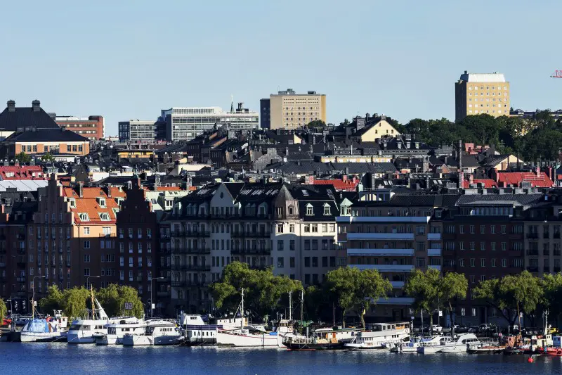 Picture of boats on water with cityscape behind